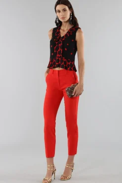 Top corto a pois con bordo asimmetrico