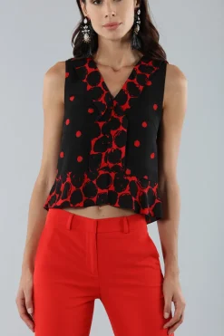 Top corto a pois con bordo asimmetrico